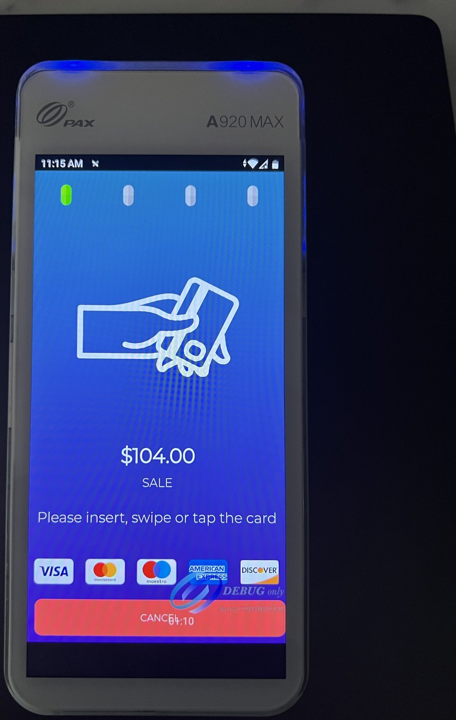 The terminal asking the customer to insert, swipe or tap the card, showing the sale amount